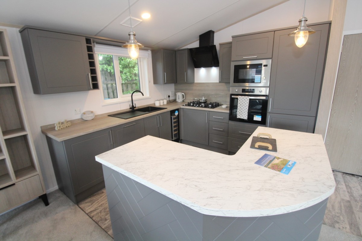 kitchen with breakfast bar in the 2023 Atlas Lilac Lodge