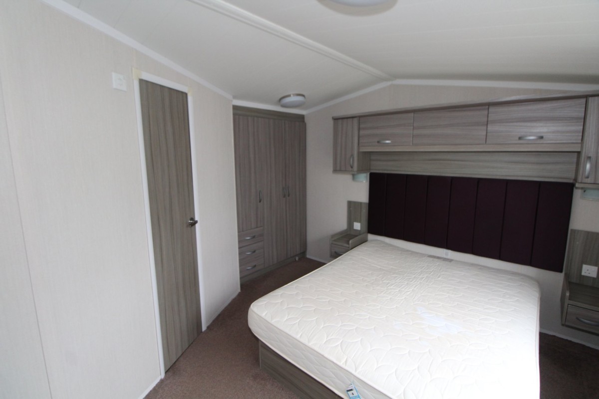 double bedroom with large headboard in the 2015 Swift Moselle