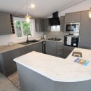 kitchen with breakfast bar in the 2023 Atlas Lilac Lodge